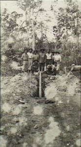 Australian soldiers dig up a German pipe mine on the Bita Paka Road.